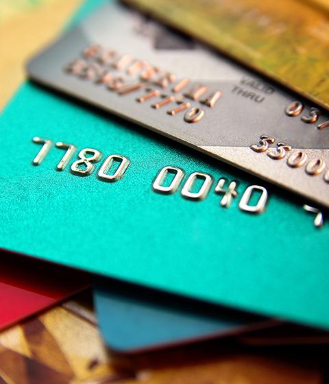 stack of multicolored credit cards, close up view with selective focus