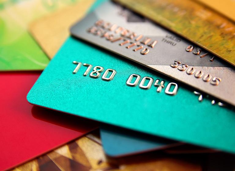 stack of multicolored credit cards, close up view with selective focus
